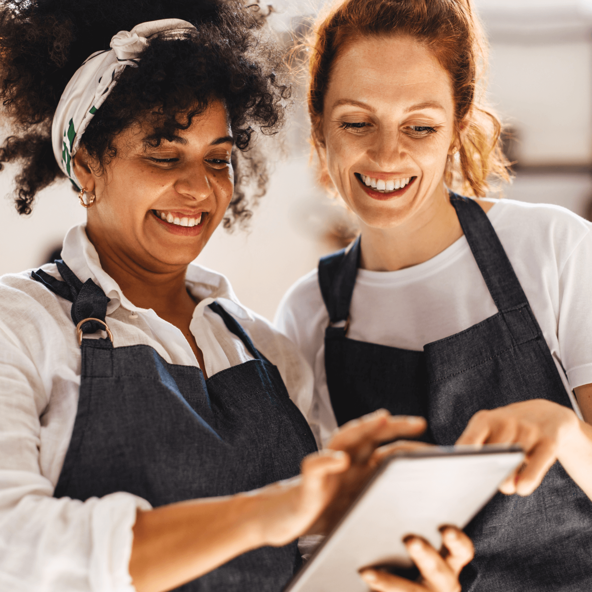 Hospitality ATS: two women in aprons with tablet